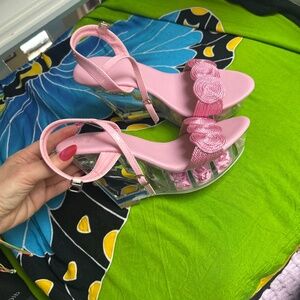 Pink shoes with roses on the bottom